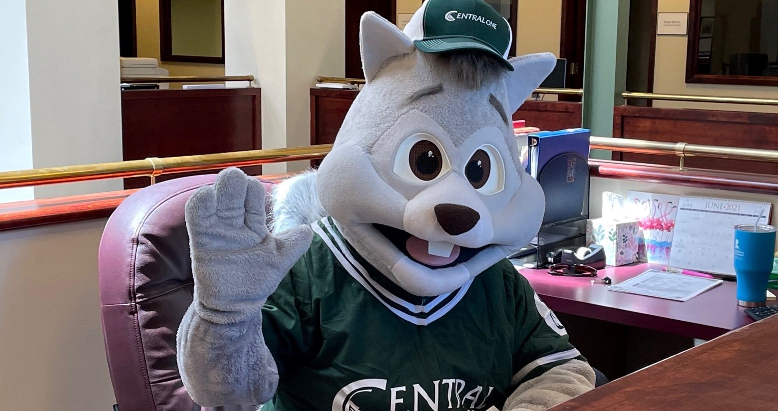 Oakie mascot sitting at reception desk