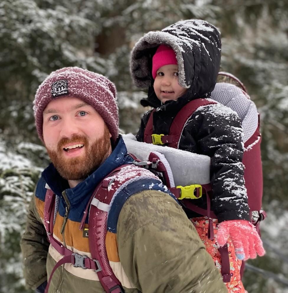 Smiling dad and child in new england snow